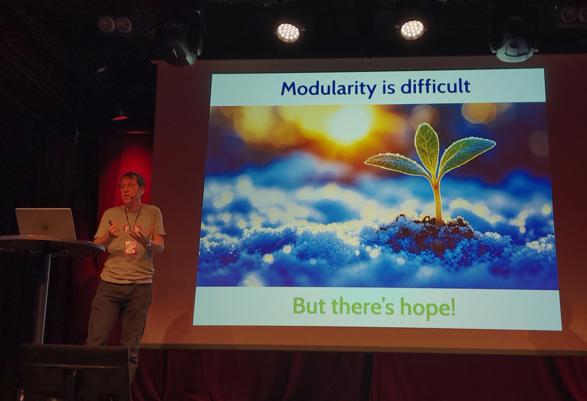 On Snowpiercer, 1001 cars long Eric presents a slide labelled "Modularity is difficult, but there's hope!"