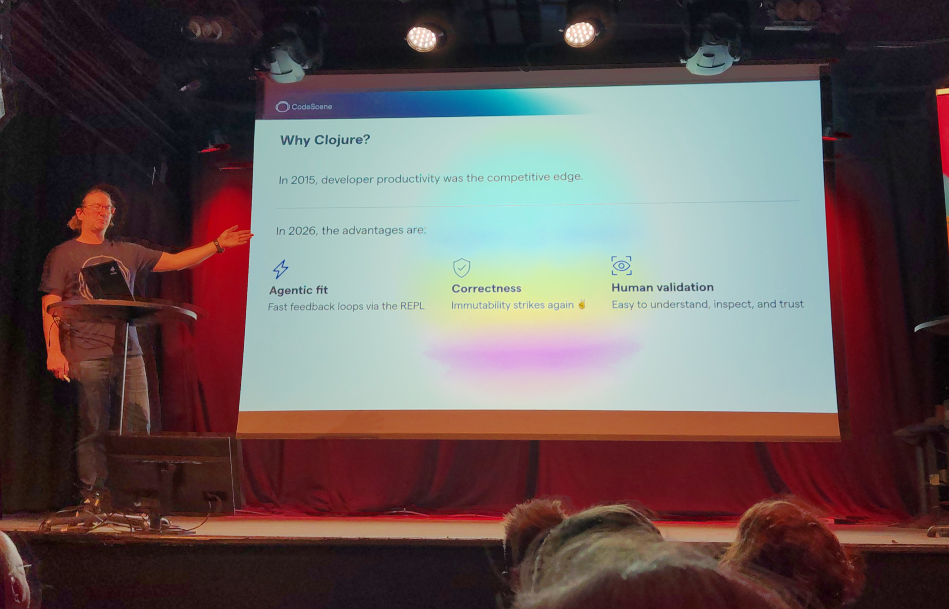 Why not? Adam presents a slide labelled "Why Clojure?"